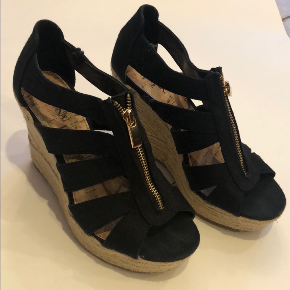 Black zip up espadrille wedge on a small platform.